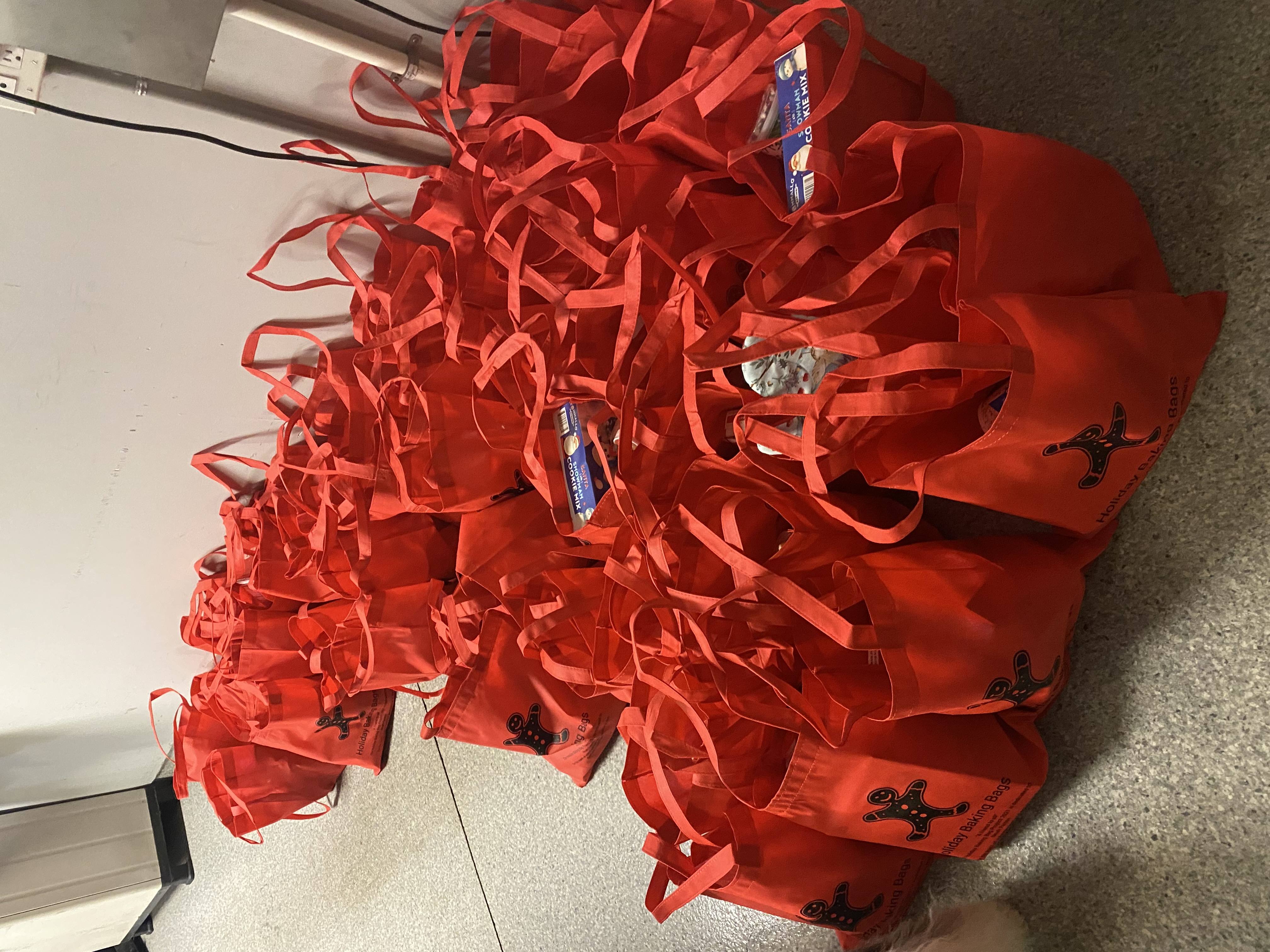 Red Holiday Baking Bags filled and ready for distribution 2016
