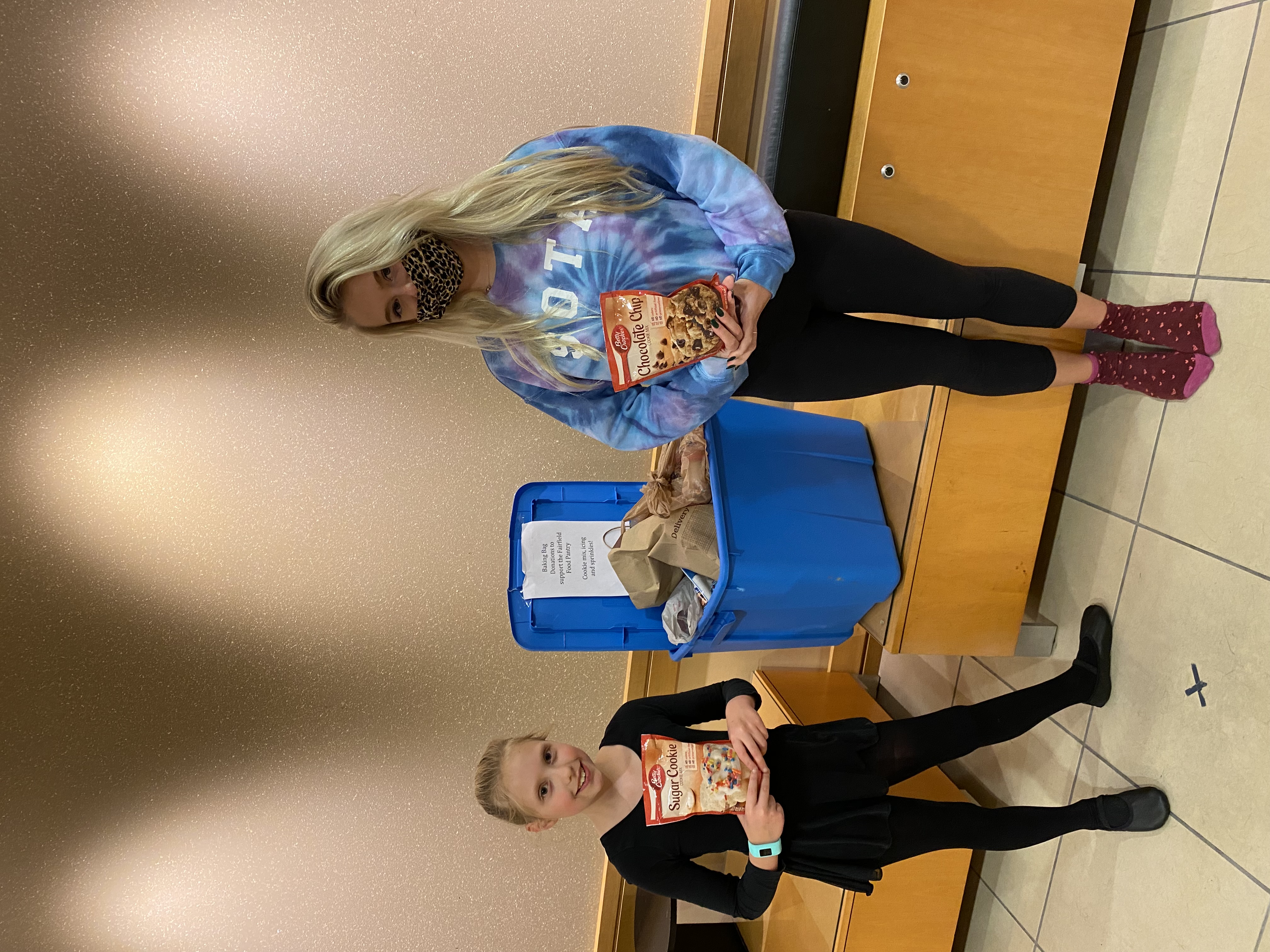 Mother and daughter donating cookie mix at collection bin 2016