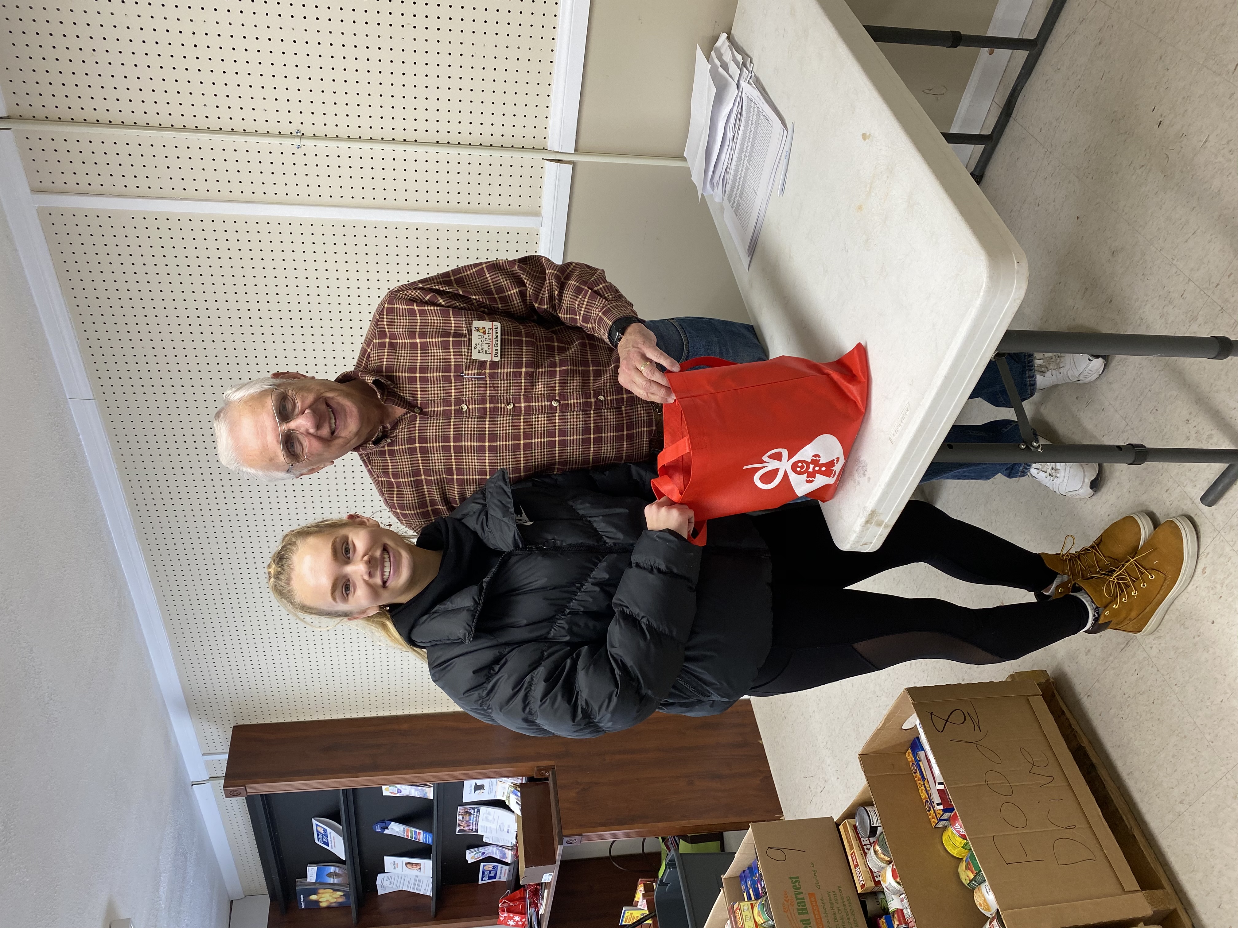 Volunteer delivering Holiday Baking Bags to food pantry 2016