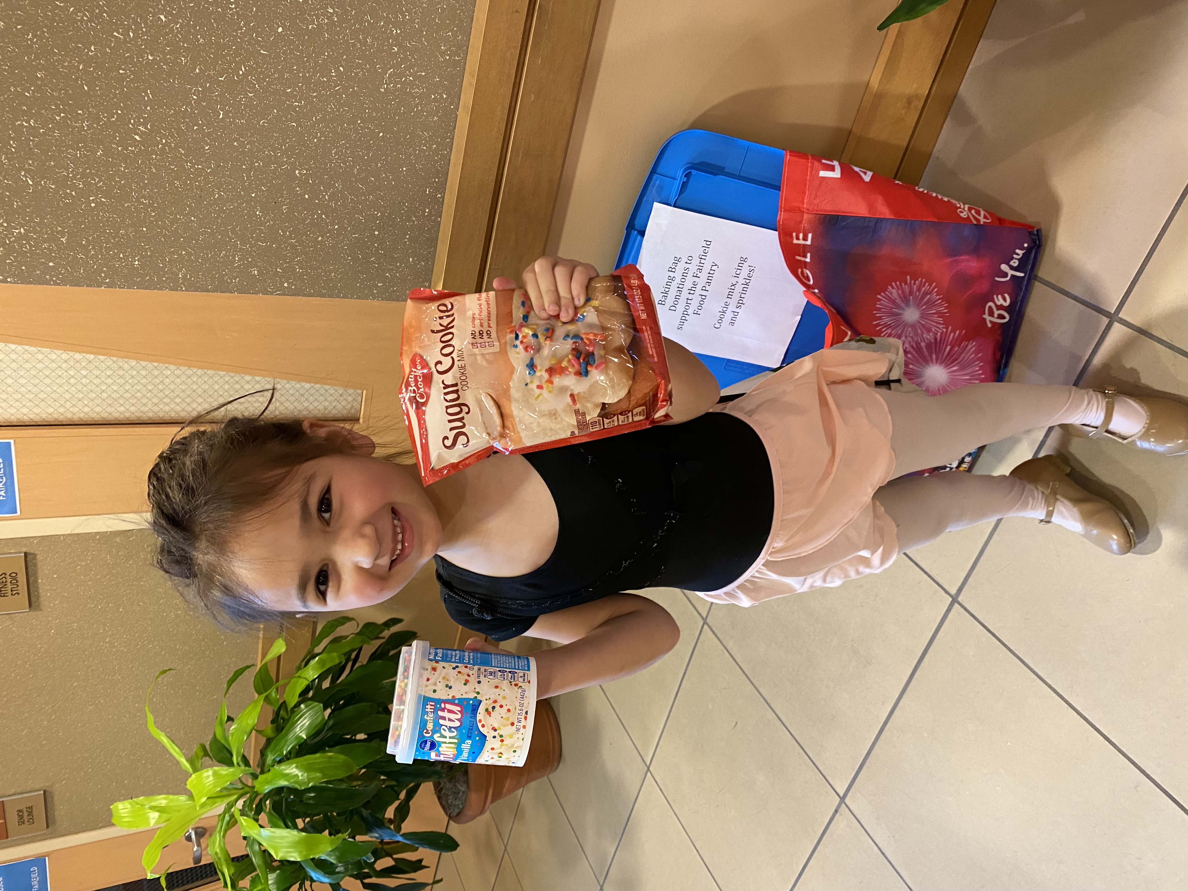 Young dancer holding sugar cookie mix and frosting donation 2016